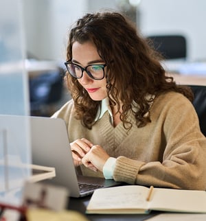 KB4-CR-0599-Busy-Young-Professional-Student-Wearing-Glasses-Laptop-800x860-Crop